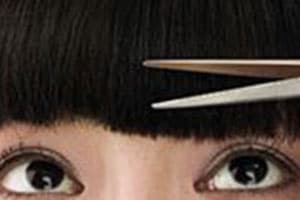 Close-up of student practicing eyelash extension techniques.