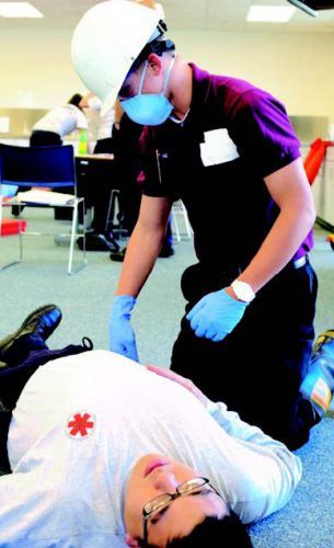 Student practicing emergency medical skills during HOSA event at Pensacola State College.