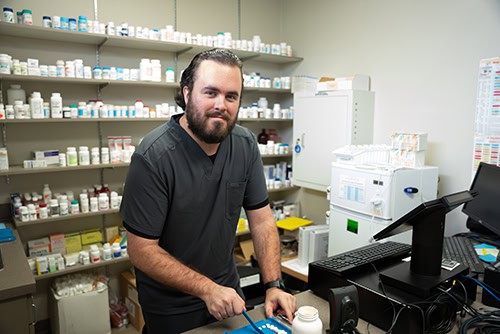 Highly skilled pharmacy technician working in a pharmacy setting at Pensacola State College.