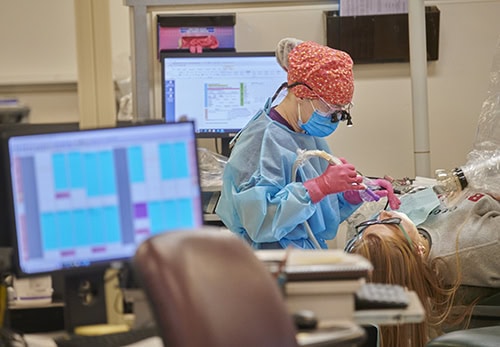 Dental hygiene student providing patient care in a clinical environment at Pensacola State College.