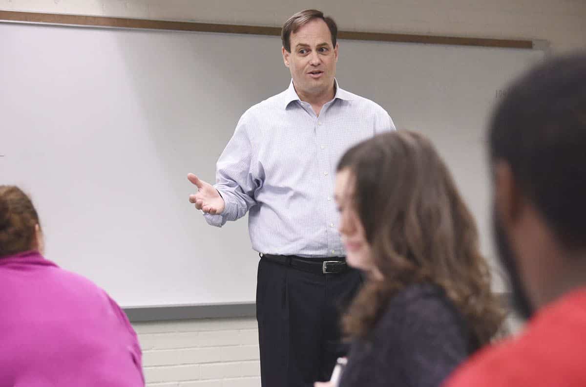 Accounting technology management lecture with students in classroom setting.
