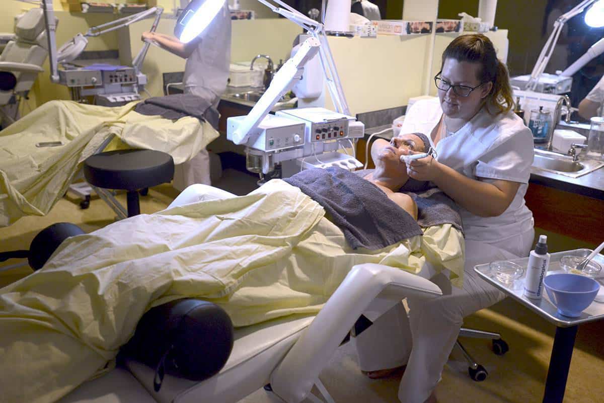Highly skilled esthetician performing skincare treatment on a client in a professional spa setting.