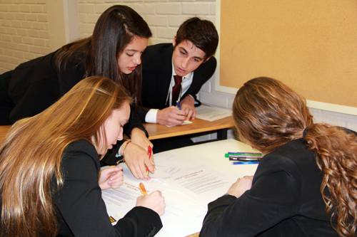 Business Development & Entrepreneurship students working together on a startup plan.