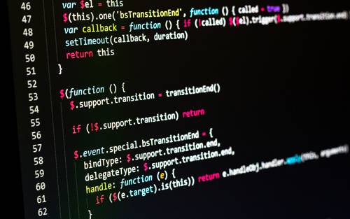 Laptop screen displaying programming code related to computer science education.