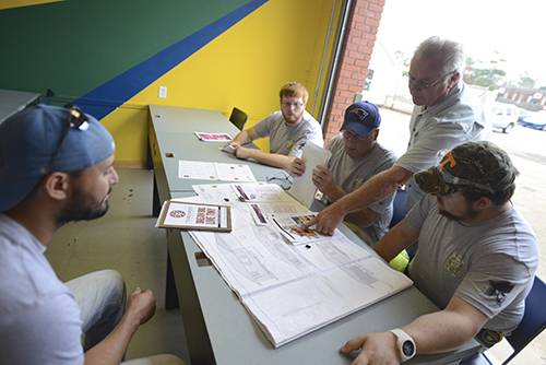 Architectural design students working on construction project plans at Pensacola State College.