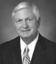 Image of a distinguished man in a suit, representing college history and leadership.