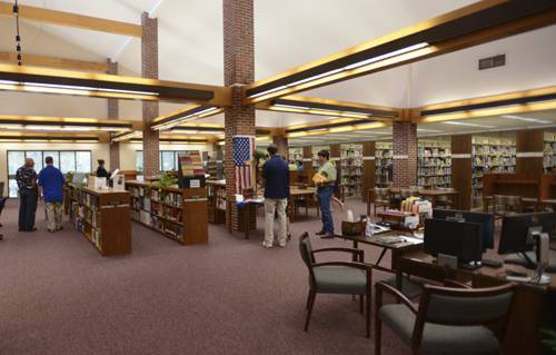 Library interior with students studying and browsing books at Pensacola State College.