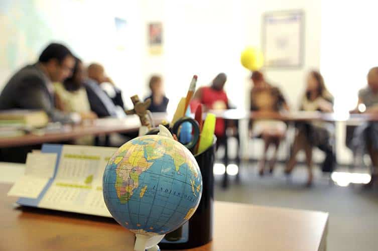 Psychology classroom with globe and students engaging in learning activities.
