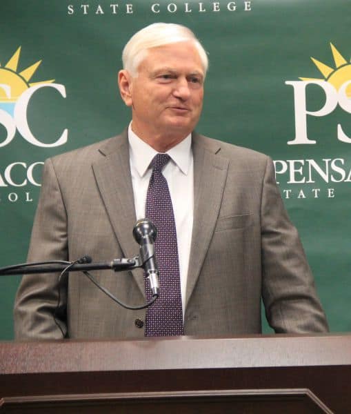 Senior male speaker at Pensacola State College announces inclusive technology initiatives.