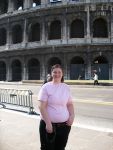 Honors Program student exploring historic Rome landmarks, Colosseum background.