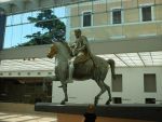 Bronze statue of a student on horseback representing academic excellence at Pensacola State College.