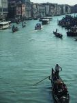 Gondola navigating Venice's iconic canals with historic architecture in the background.