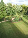 Lush campus garden with trees and flower beds at Pensacola State College Honors Program.