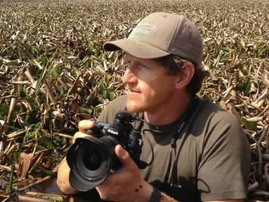 Conservation photographer capturing wildlife in natural habitat at Pensacola State College.