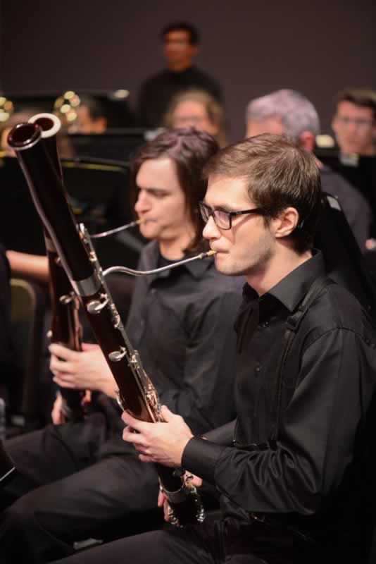 Wind ensemble and jazz ensemble students playing during a free college concert.