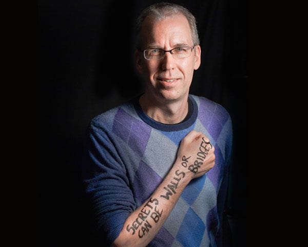 PostSecret founder sharing personal stories at Pensacola State College event.