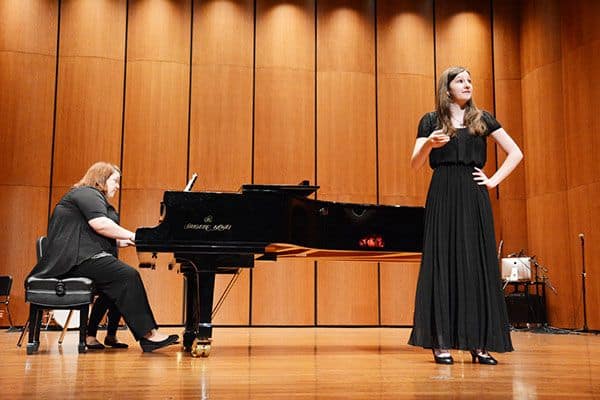 Piano and singer performing on stage at Pensacola State College.