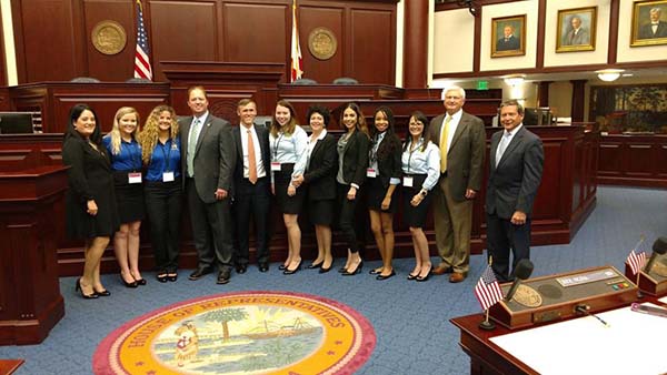 Students and officials pose together during a Capitol tour.