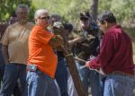 Instructor demonstrating tree cutting techniques to students outdoors at Pensacola State College.