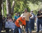 Lumberjack performing woodcutting skills during outdoor college event at Pensacola State College.