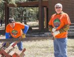 Lumberjack festival volunteers participating in outdoor woodcutting activity at Pensacola State Coll.
