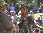 Lumberjack event with participants and spectators at Pensacola State College campus.