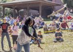 Lumberjack student demonstrating axe skills during outdoor college event at Pensacola State College.