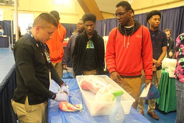 Students engaging in SkillsUSA competition at career expo event.