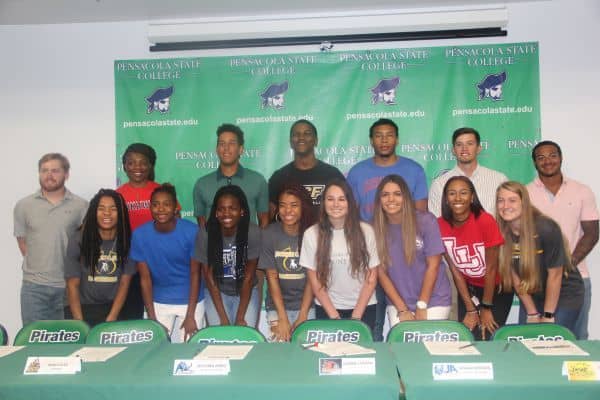 Student-athletes signing college sports scholarships at Pensacola State College for higher education.
