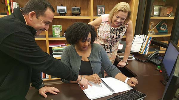 Students working together on academic projects in a college library setting.