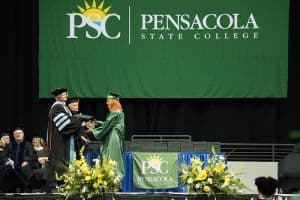 Graduates receiving diplomas during Pensacola State College commencement ceremony.