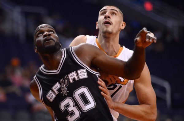 Basketball player in action during game, showcasing athleticism and competitive spirit.