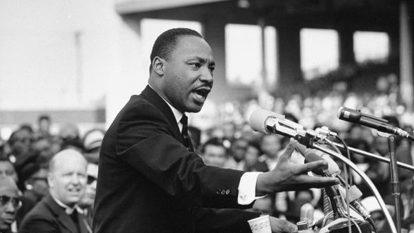 Civil rights leader speaking passionately at a community event at Pensacola State College.