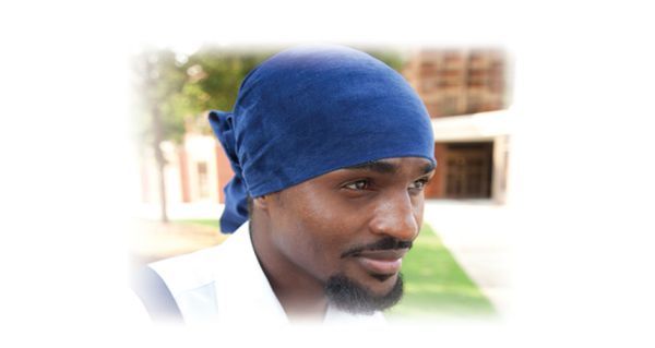 Egyptian performer with blue headscarf at PSC's free Black Men Naked Truth event.