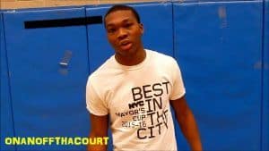Young male basketball player standing in front of blue gymnasium wall, representing PSC men's basket.