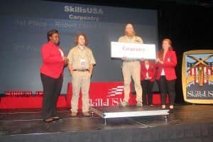 Pensacola State students on stage winning at SkillsUSA carpentry contest.
