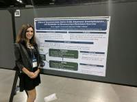 Pensacola State College instructor presenting research at academic meeting.