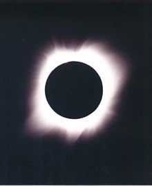 Close-up of a solar eclipse with the moon covering the sun, creating a stunning corona effect.