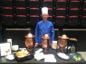 Chef preparing food at Pick A Bowl Fill A Bowl 10th anniversary event.