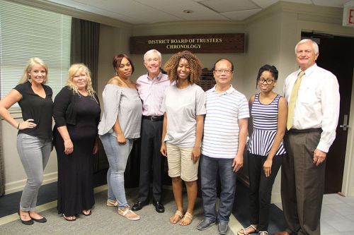 Diverse group of students and faculty at Pensacola State College meeting.