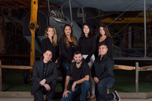 Student graphic design team at the National Naval Aviation Museum, showcasing innovative artwork and.