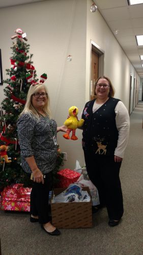 Holiday event at Pensacola State College featuring staff and Christmas decor.