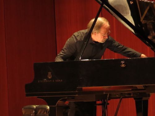 Experienced faculty member playing piano at Golden Key academic competition.