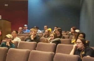 Students attending a cybersecurity seminar on internet threats and online safety.