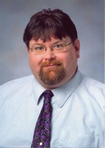 Professor teaching philosophy to students at Pensacola State College campus.