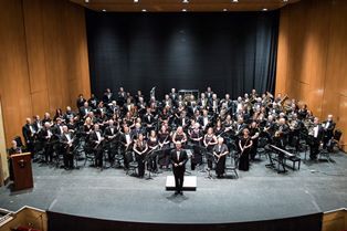 High school and college musicians perform at Pensacola State College auditorium for community healin.