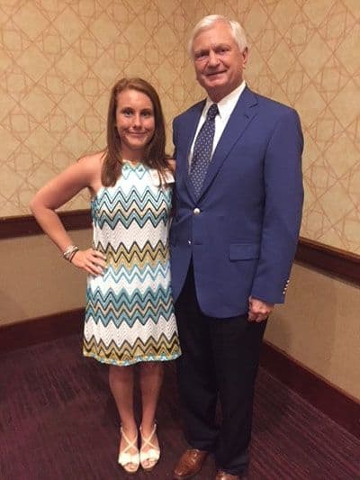 College student and faculty member at Pensacola State College posing together in formal setting.