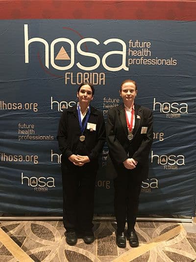 HOSA Florida future health professionals conference with students in formal attire and medals.