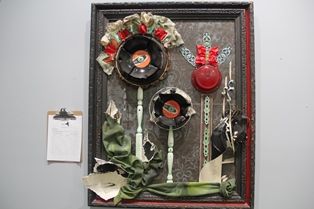 Holiday-themed repurposed art display at Pensacola State College for Habitat for Humanity event.