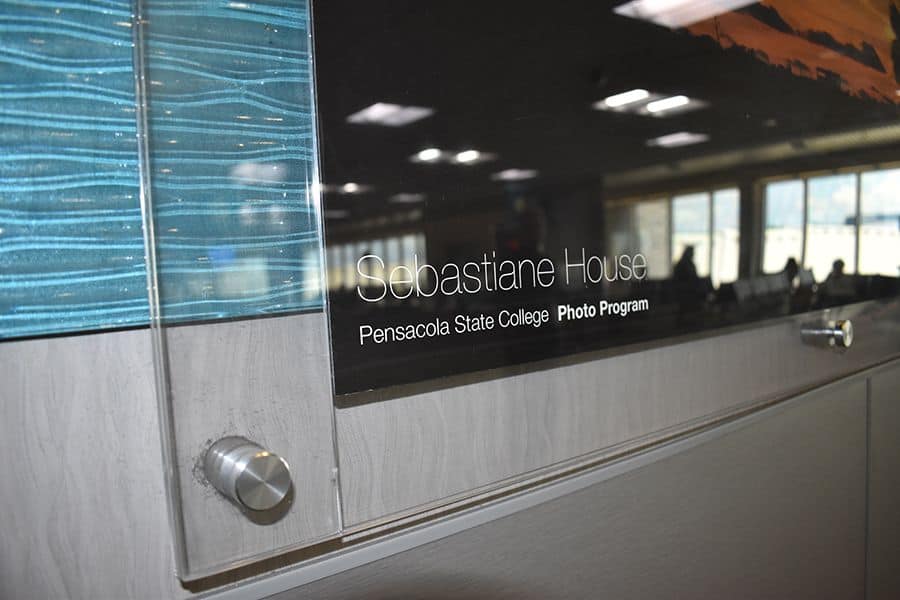Modern college reception desk with Pensacola State College branding.